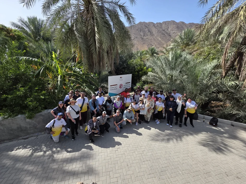 A corporate wellbeing retreat team gathered among the palm trees