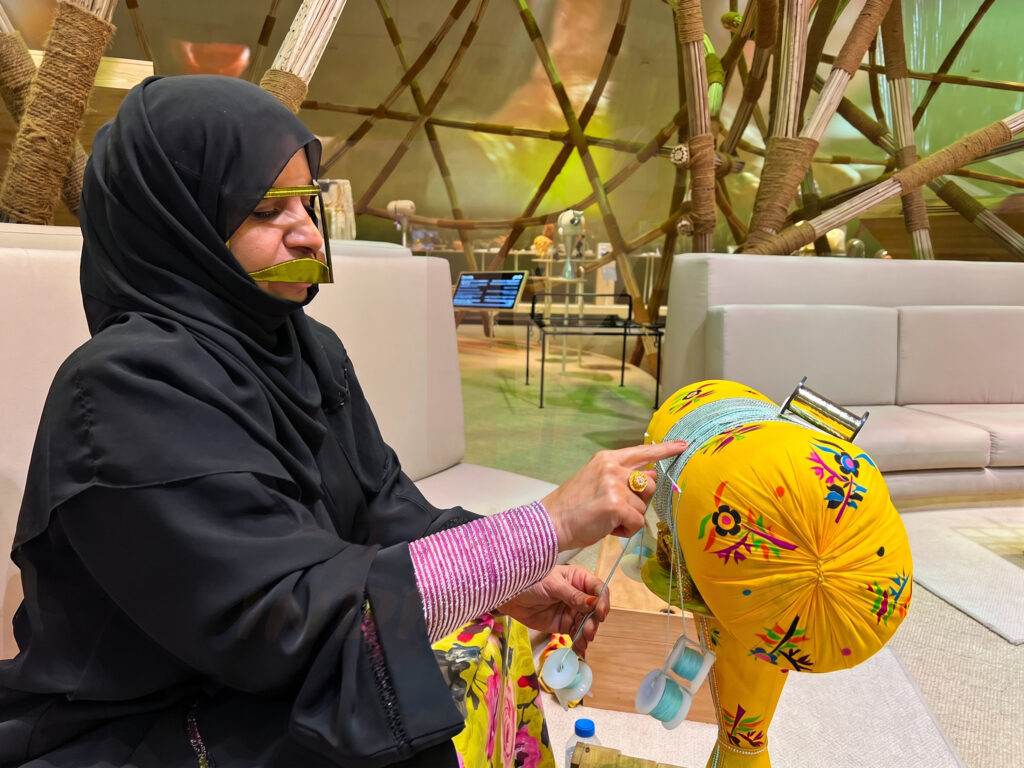 Emirati artisan weaving Talli, traditional braided embroidery