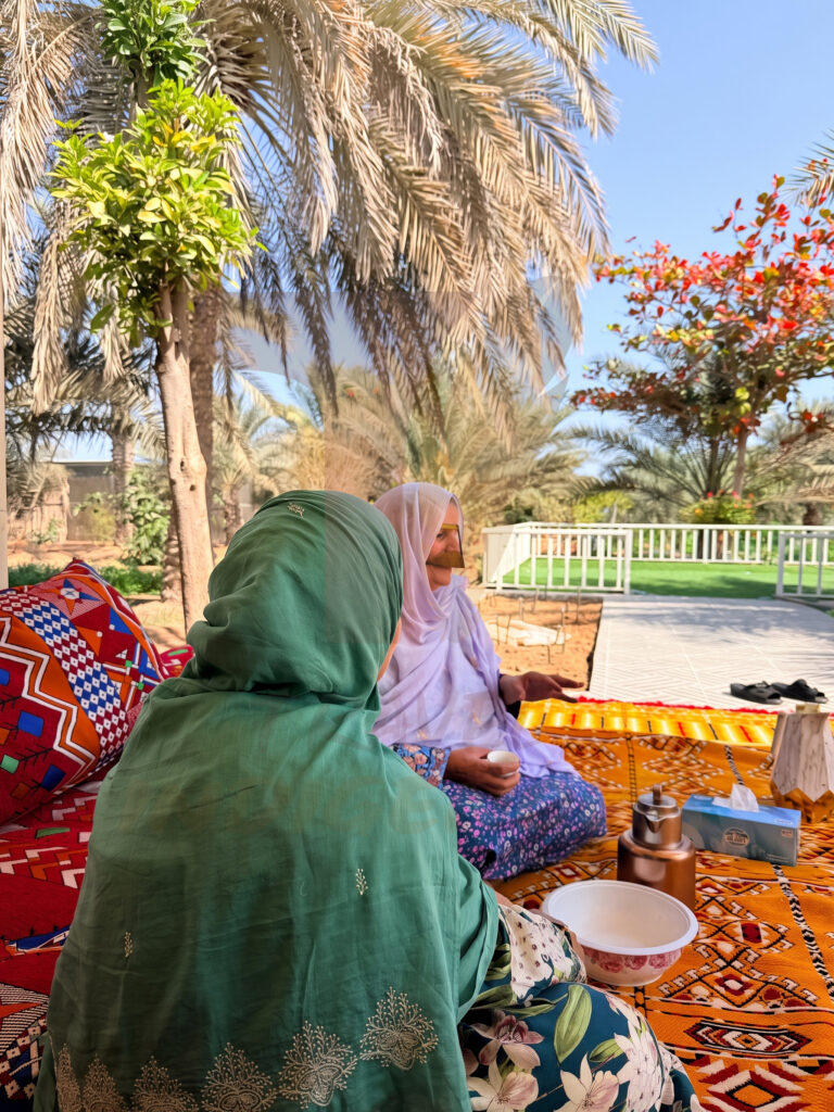 emirati hosts traditional majlis Emirati hosts welcoming guests in a traditional outdoor majlis