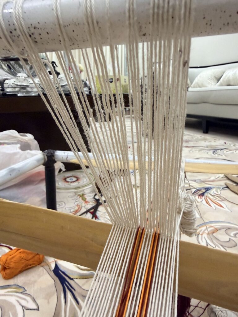 Warp threads stretched across a Sadu ground loom