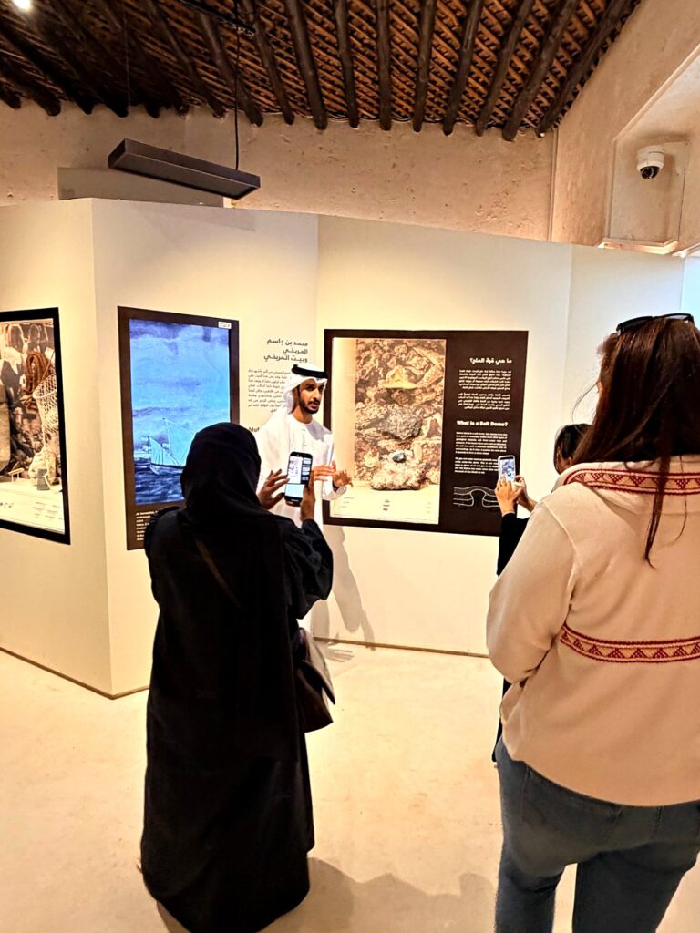 A local guide sharing stories with guests in a heritage house